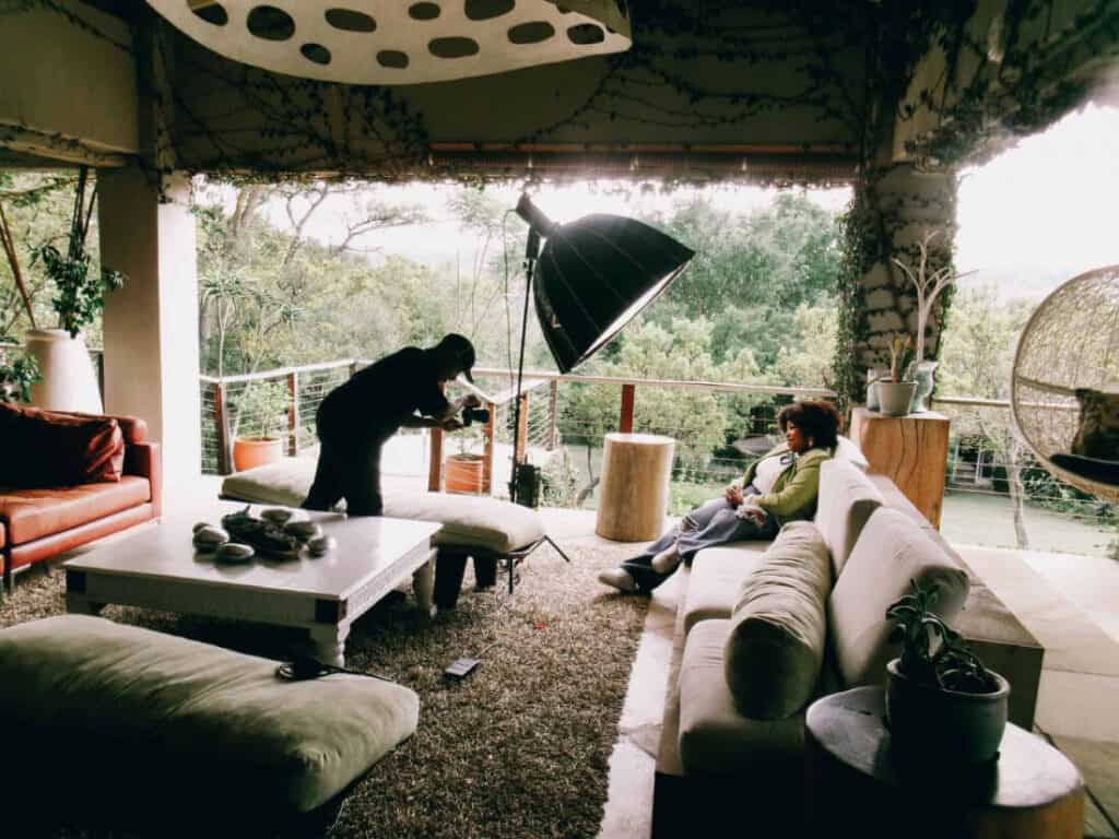behind the scene shot of woman on coach and a videographer