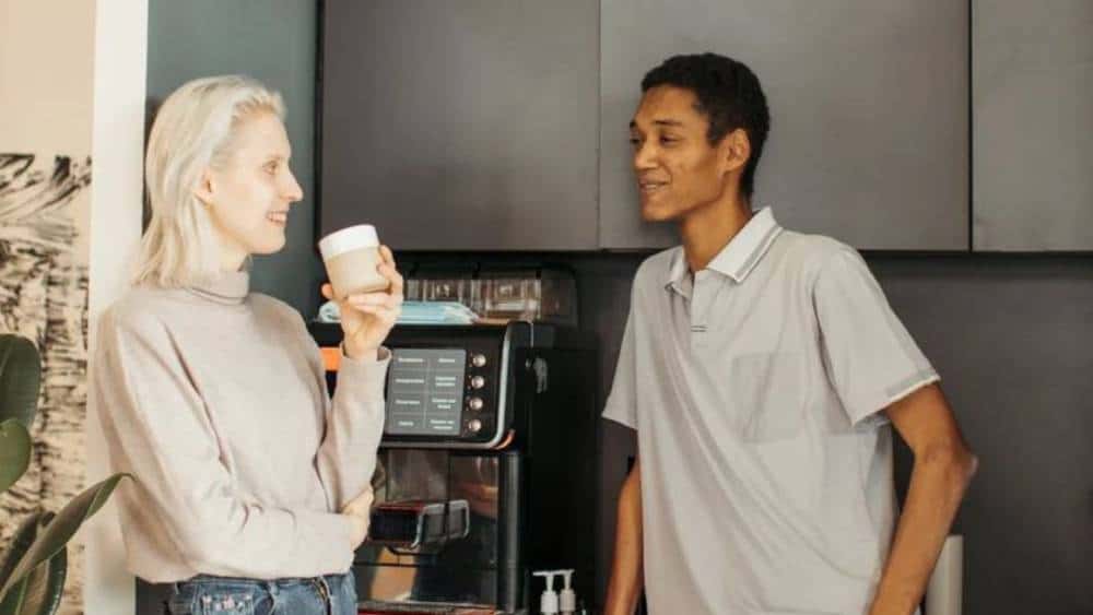 coworker discussion in near coffee station
